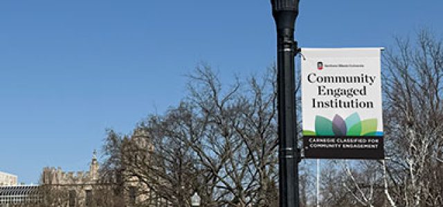light post banner mockup with "Community Engaged Institution" and logo