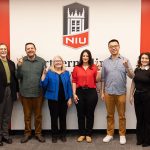 Melissa Fickling, TJ Schoonover, Suzanne Degges-White, Dana lsawi, Peitao Zhu, and Yenitza Guzman pose with Huskie hand gentures.