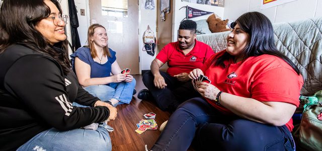 students playing Uno on a dorm room floor