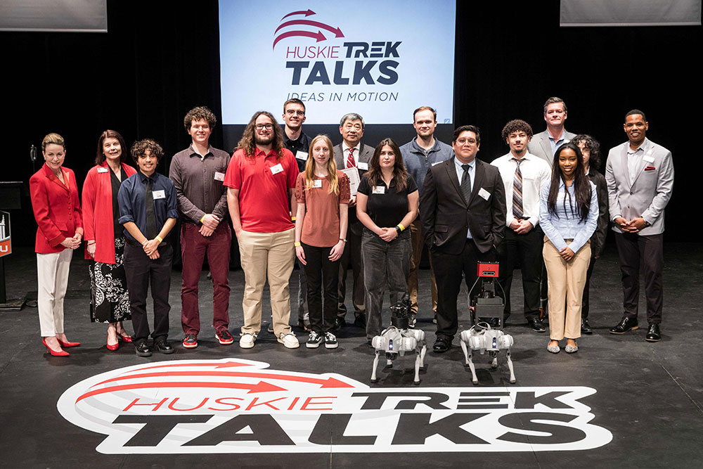 NIU students with two robotic "guide dogs"